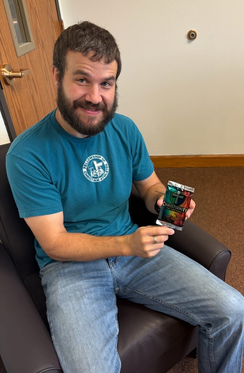 Pastor Mark Sina holding a booster pack
